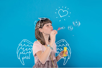 Soap bubbles. Calm relaxed teenage girl blowing bubbles while having free time