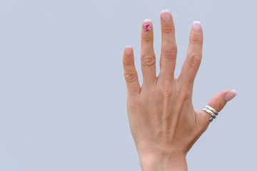 Hand of an older woman with manicured nails