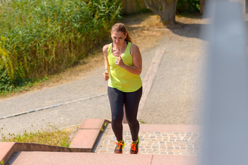 Woman running while climbing stairs during workout