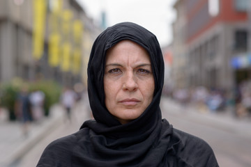Woman wearing a head scarf in an urban street