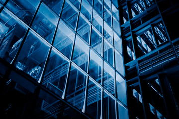 Close up of modern skyscraper illuminated at night.