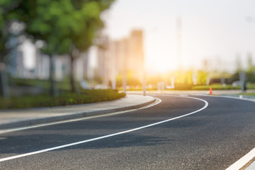 city empty traffic road with cityscape in background.