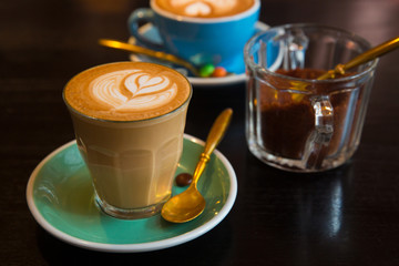 Cup of art shaped designed latte or cappuccino coffee