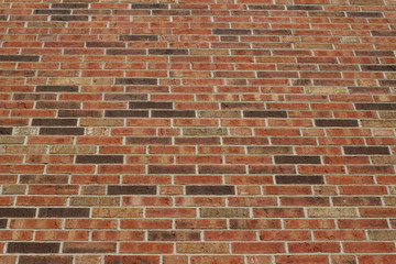 Low angle view of a vintage brown multi-tone brick wall background with Flemish stretcher bond brickwork pattern