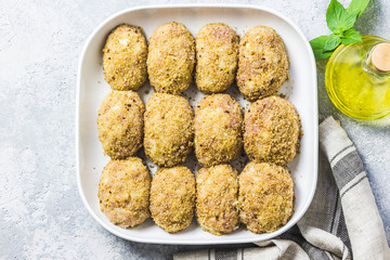 Healthy oven baked chicken rissoles on baking dish, ready for cooking. Top view, space for text.
