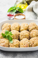Healthy oven baked chicken rissoles on baking dish, ready for cooking. Selective focus, space for text.