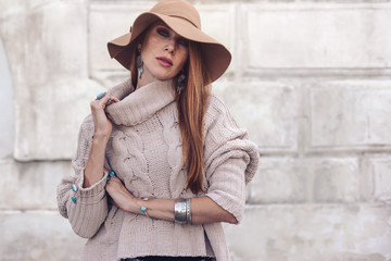 Model in fall cozy sweater and boho jewellery