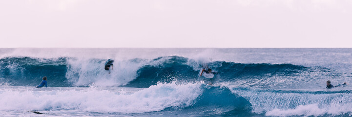 Young surfers takes the waves, vintage style photography.
