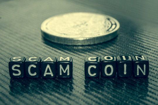 Words Scam coin made of black cubes on grey.