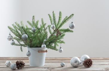 Christmas fir in bucket on old wooden table