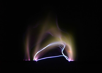Electric arc between two electrodes seen on a black background.