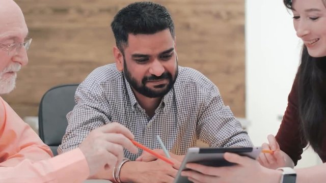 Mature company head explaining his young employees