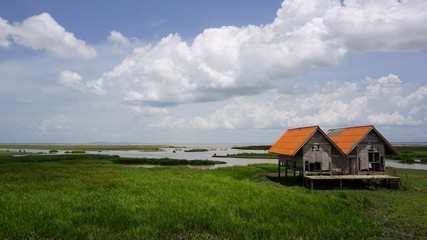 A landscape view of an old house by the lake located in Thanon Chaloem Phra Kiat 80 Phansa, Phatthalung, Thailand.