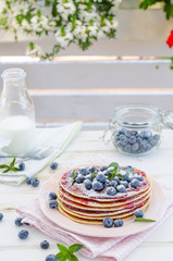 Vintage pancakes outside garden with blueberries