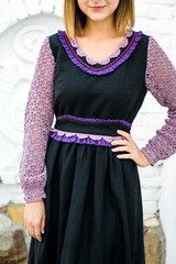 The girl in black dress from flax, lace lilac sleeves, close-up