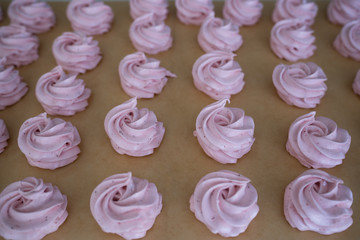 Making French meringue cookies marshmallows on parchment paper