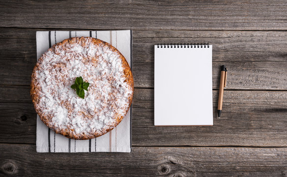 Homemade cake. There is a notepad to accommodate your recipe.