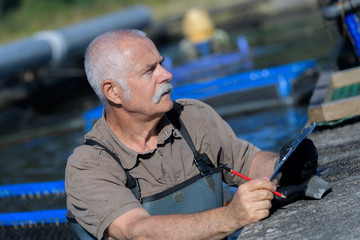 aquaculture worker doing his surveys