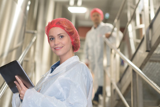 Female Food Factory Worker With Protection Hat And Coat