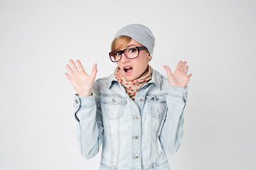 Young hipster surprised woman  in winter hat and glasses