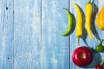 autumn vegetables with shadow on worn blue wood table background