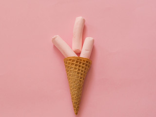 Marshmallow in ice cream cone on pink