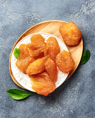 Candied sliced pear. Dried fruits on gray background. Top view.