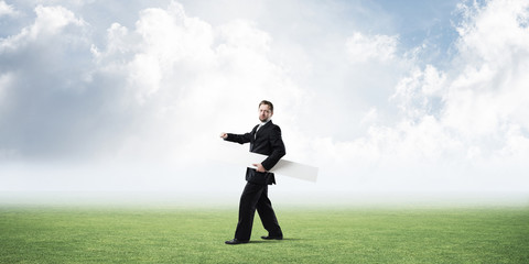 Conceptual image of businessman pointing aside