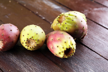 Fruits of the prickly pear cactus on a rustic table.