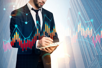 Businessman with planner, graph in city