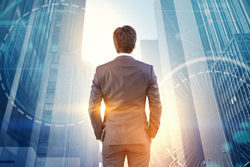 Businessman looking at city, hud and network