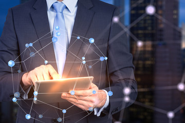 Businessman with tablet, network in city