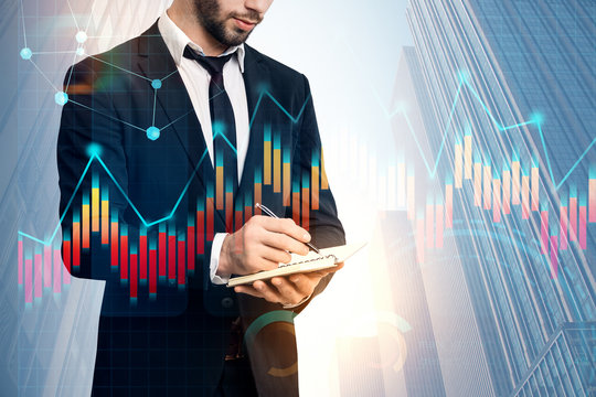 Businessman with planner, graph in city