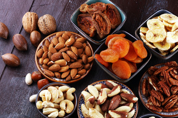 dried fruits and assorted nuts composition on rustic table