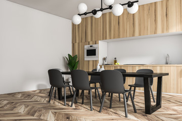 Wooden kitchen interior, black table, side view