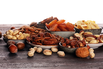 dried fruits and assorted nuts composition on rustic table