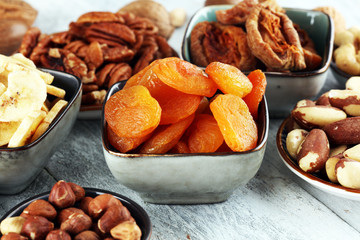 dried fruits and assorted nuts composition on rustic table