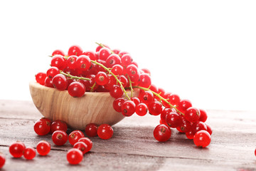 Fresh red currants on light rustic table. Healthy summer fruits