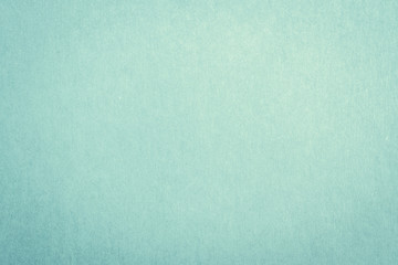 Recycled craft paper textured background in light green cyan blue color .