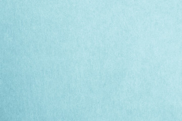 Recycled craft paper textured background in light cyan blue color .