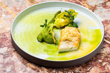 Fine dining, white fish fillet breaded in herbs and spice with asparagus