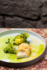 Fine dining, white fish fillet breaded in herbs and spice with asparagus
