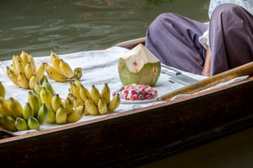 Colored fruits in floating market, fruit seller in Thailand, typical thai floating market background