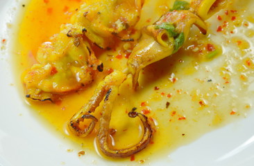 grilled squid dressing spicy sauce on white plate