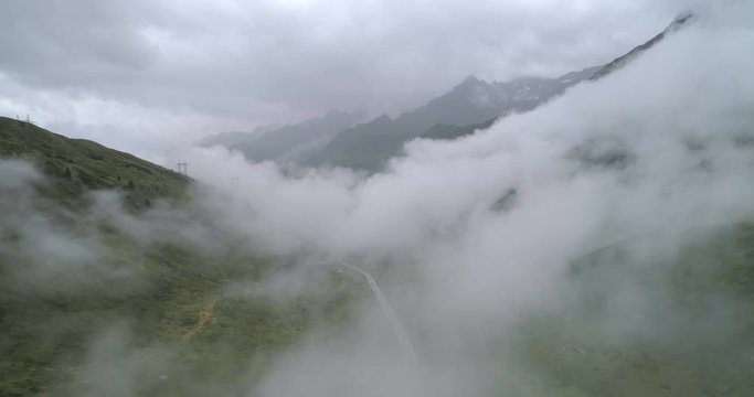 Cars on cloudy mountain road - Aerial 4K