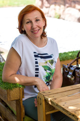 elderly woman with red hair on the street