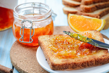 Slices of toasted bread with orange jam for breakfast