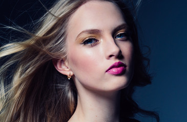 Beautiful blonde hair woman with beauty makeup pink lipstick