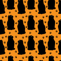 Obraz premium black cats pattern on orange background for holiday