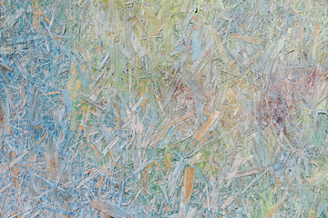 Colorful (green, blue and yellow) painted OSB board as background, texture